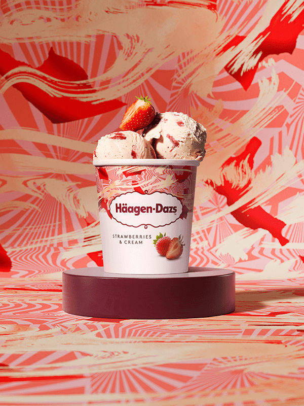 haagen dazs strawberries & cream ice cream pint arranged on a patterned red background